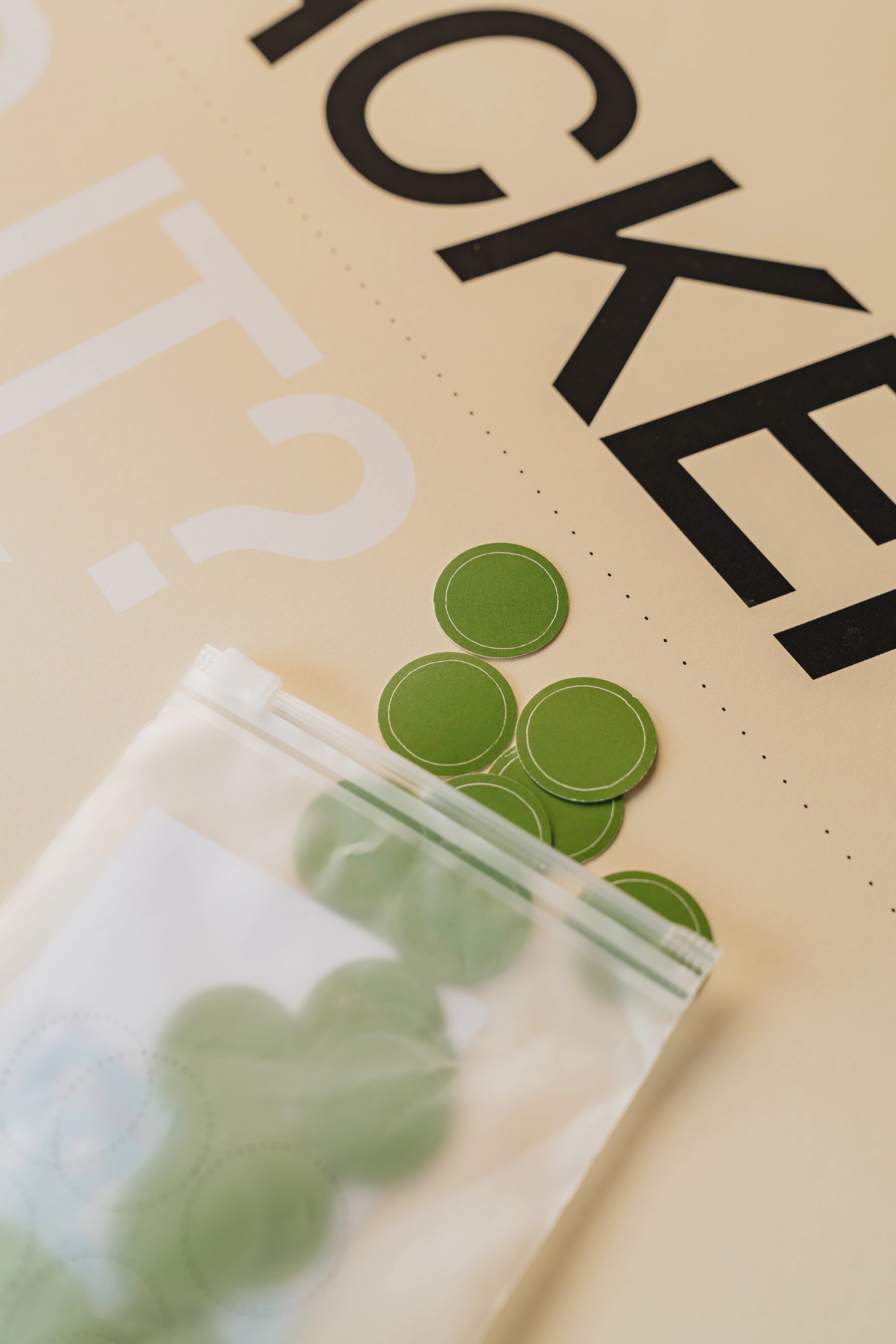 Close-up of green circular objects on a beige surface with text.