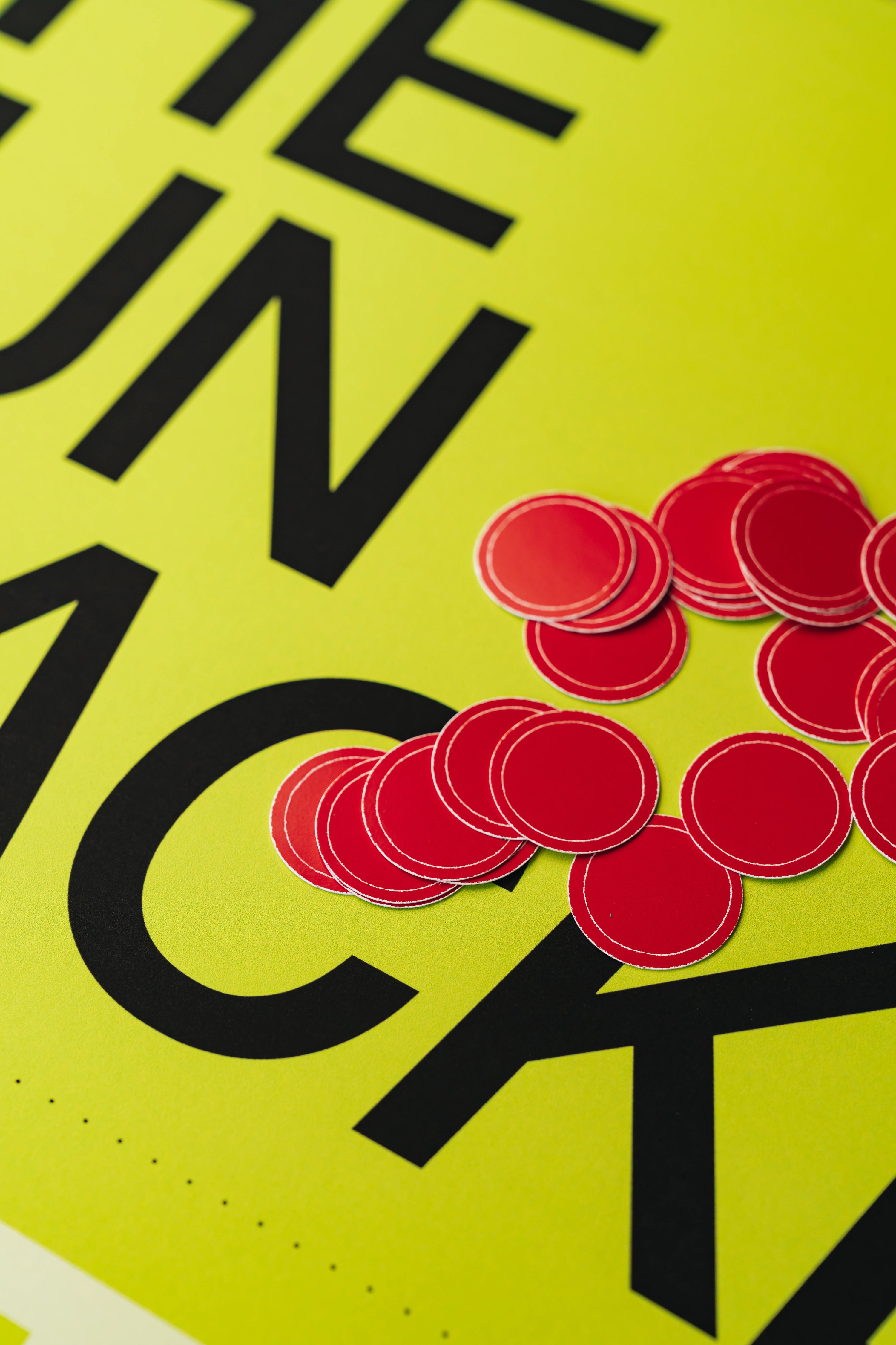 Red circular objects on a yellow background with black text