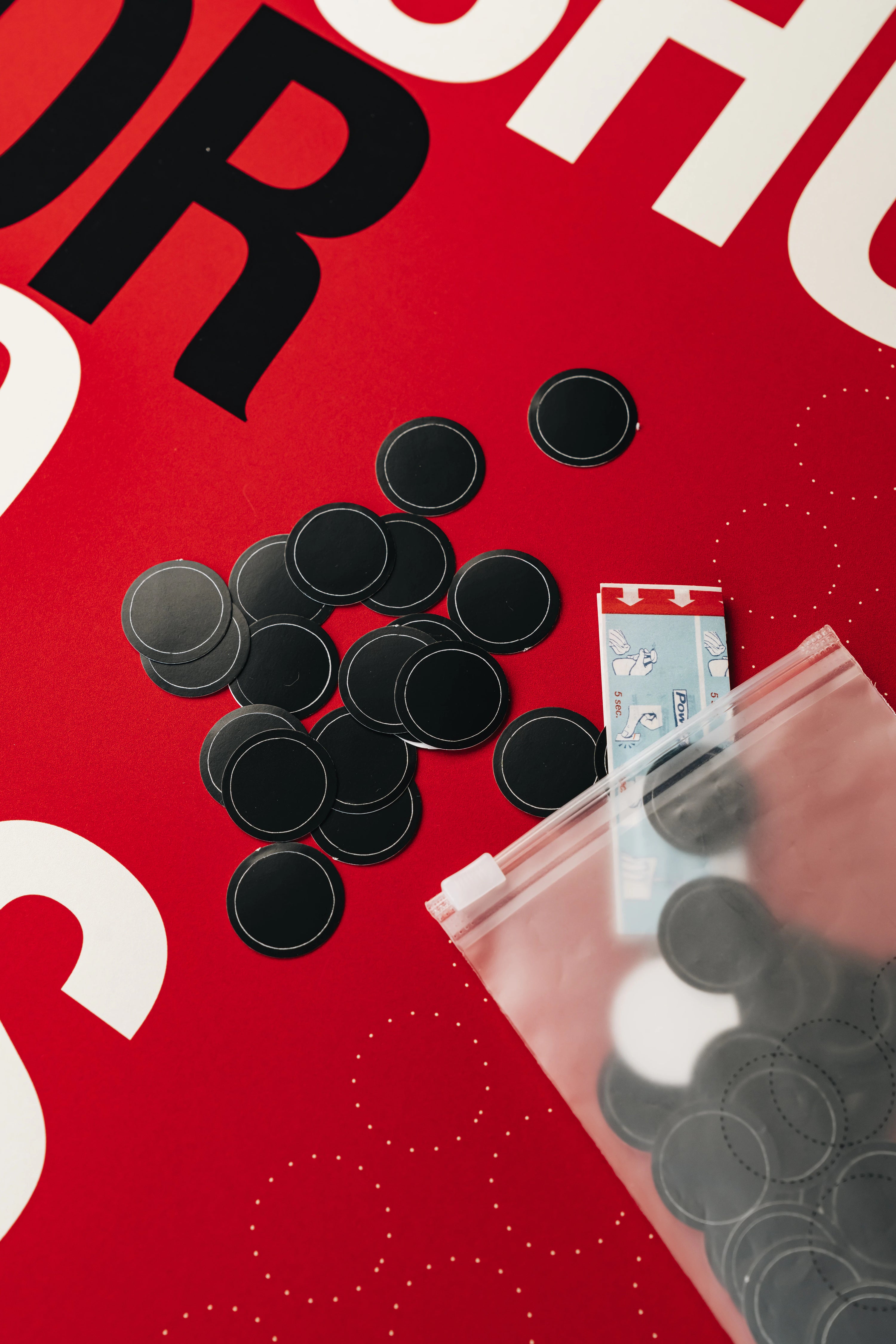 Black buttons on a red surface with text partially visible